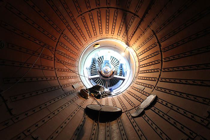 Workers take apart equipment at an OPPD peaking station