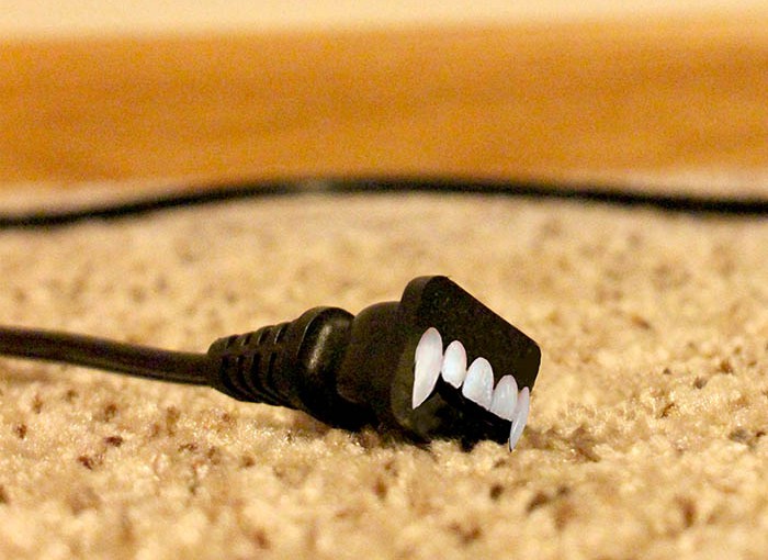 vampire energy, an electrical plug with vampire teeth
