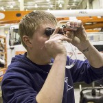 Laborer Seth Hanson inspects a part at OPPD’s Elkhorn Service Center garage.