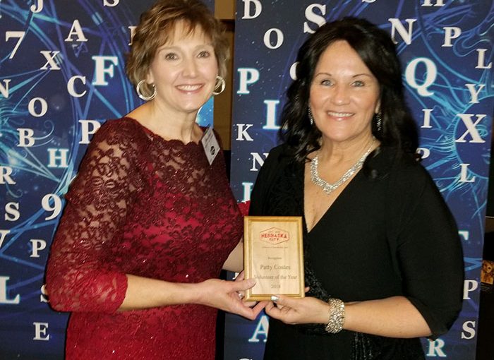 COM_Patty Coates_with award