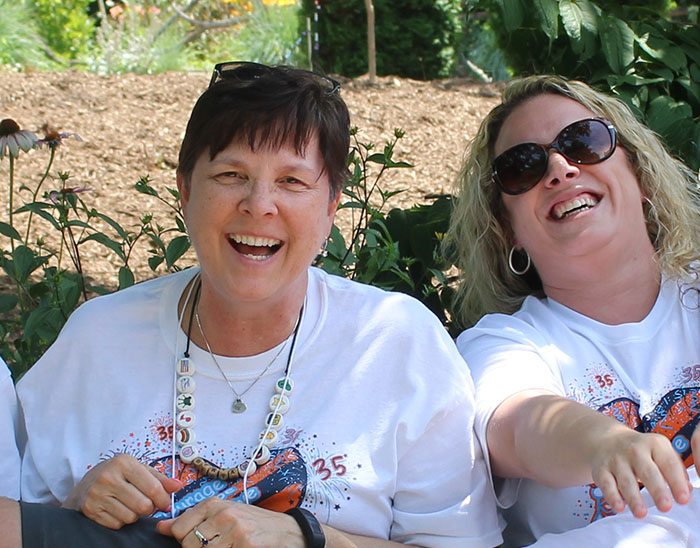 OPPD employee Berta Ackerson with volunteers at Camp CoHoLo.