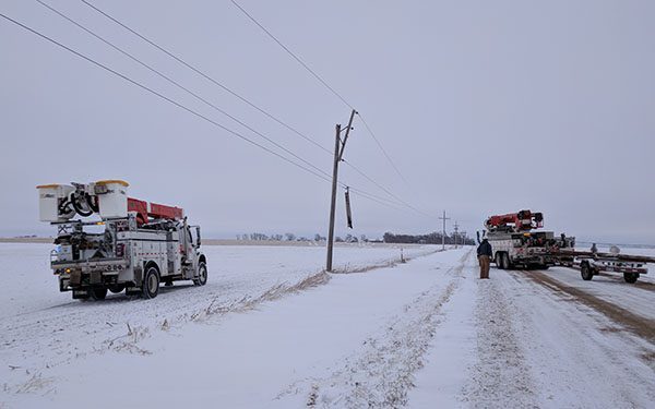 galloping power lines, bucket trucks on the side of the road in winter